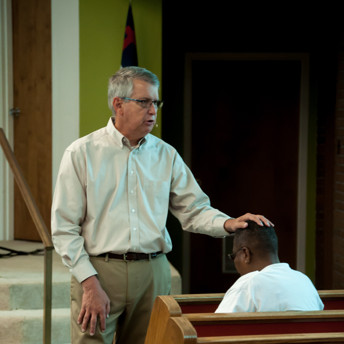 Minton Praying at healing School