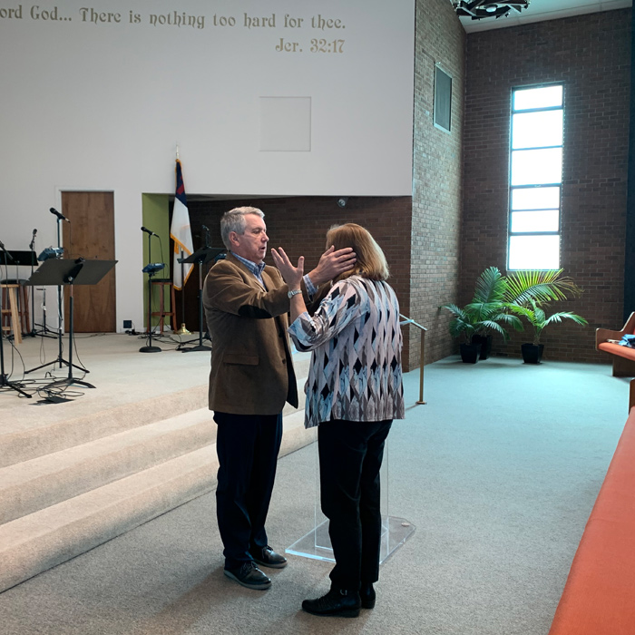 Praying at HPC Healing School